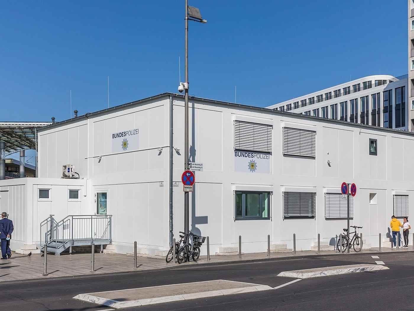 A finished modular building in service, with signage, planting and a paved approach